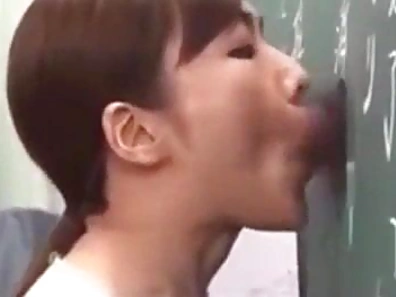 Seductive Japanese Teacher Engages in Steamy Glory Hole Action